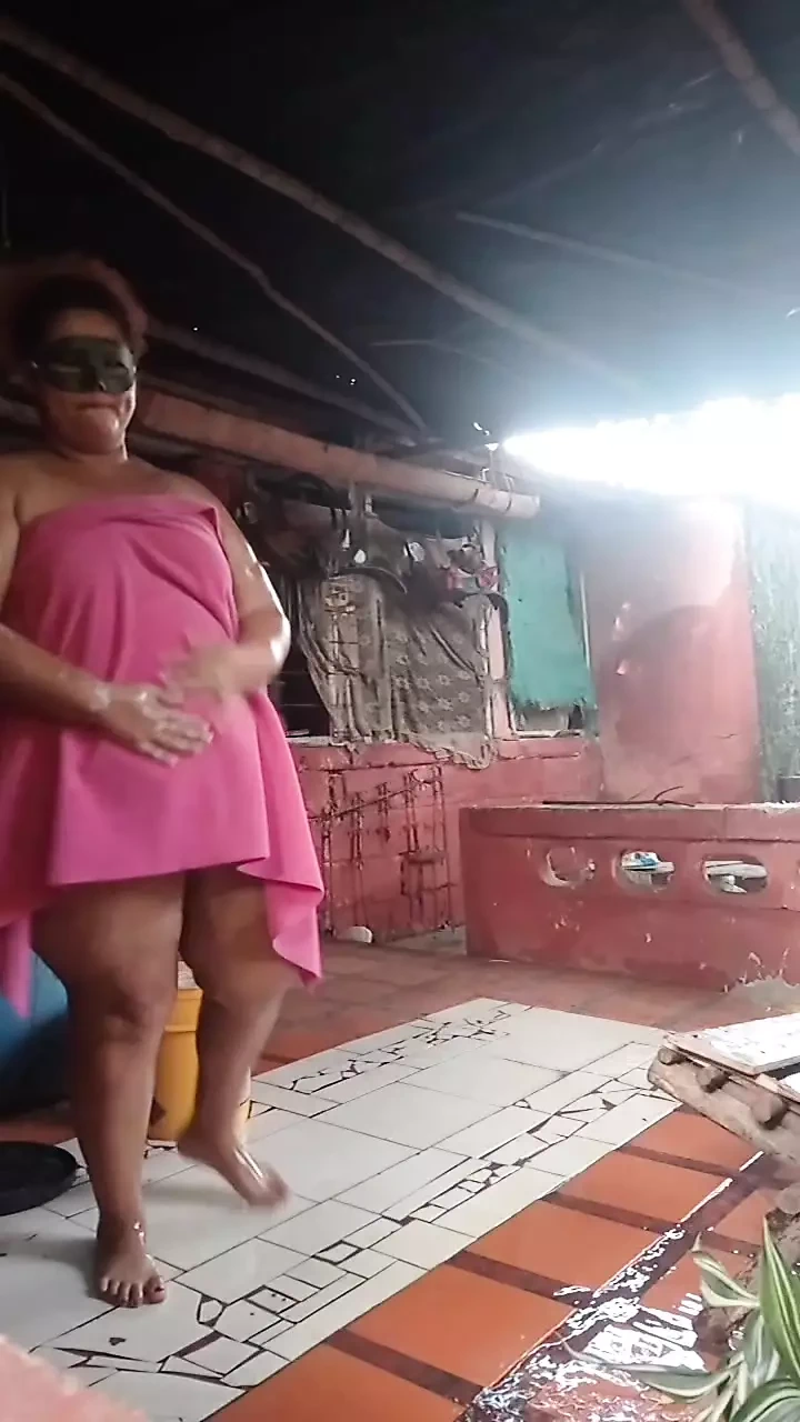 Naked mom in the yard bathing.