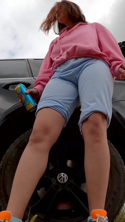 Hipster girl pee with her legs wide opened outdoor
