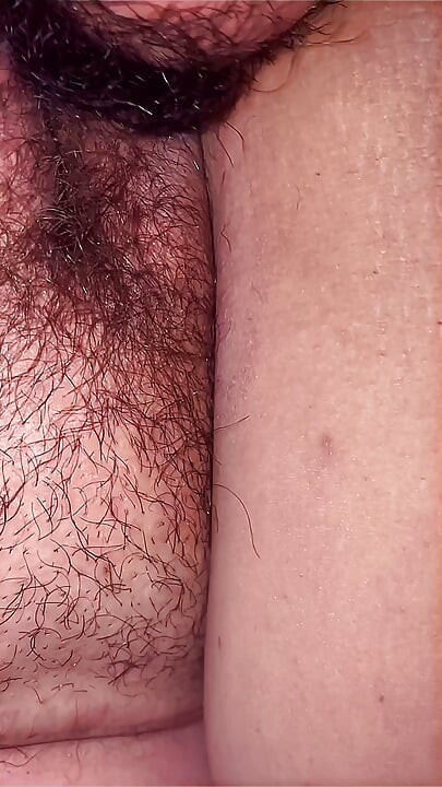 A lustful masseur caught the MILF off guard and licked her all over from behind, exploring her hairy pussy