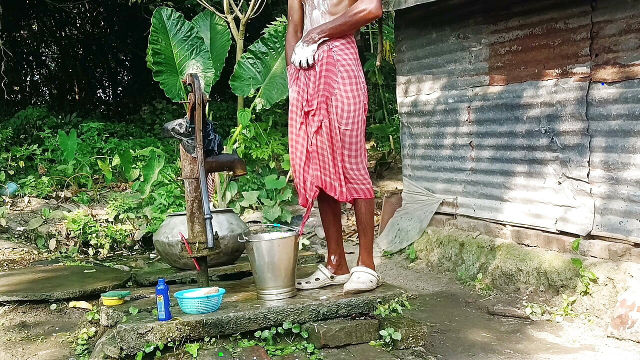 Desi young man bath Open place.