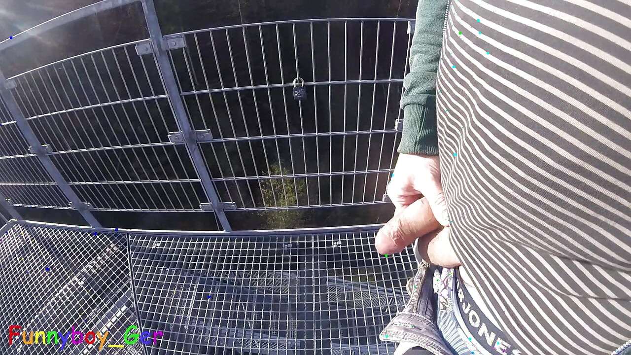 I'm working on my foreskin cock outside on a very public observation tower by a river.