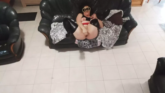 In black latex with black dildo