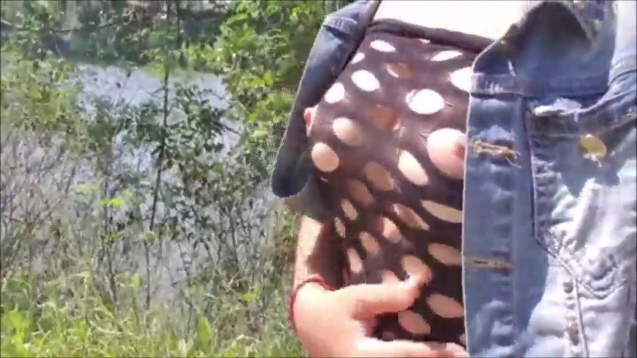 Busty lady gets off in the open