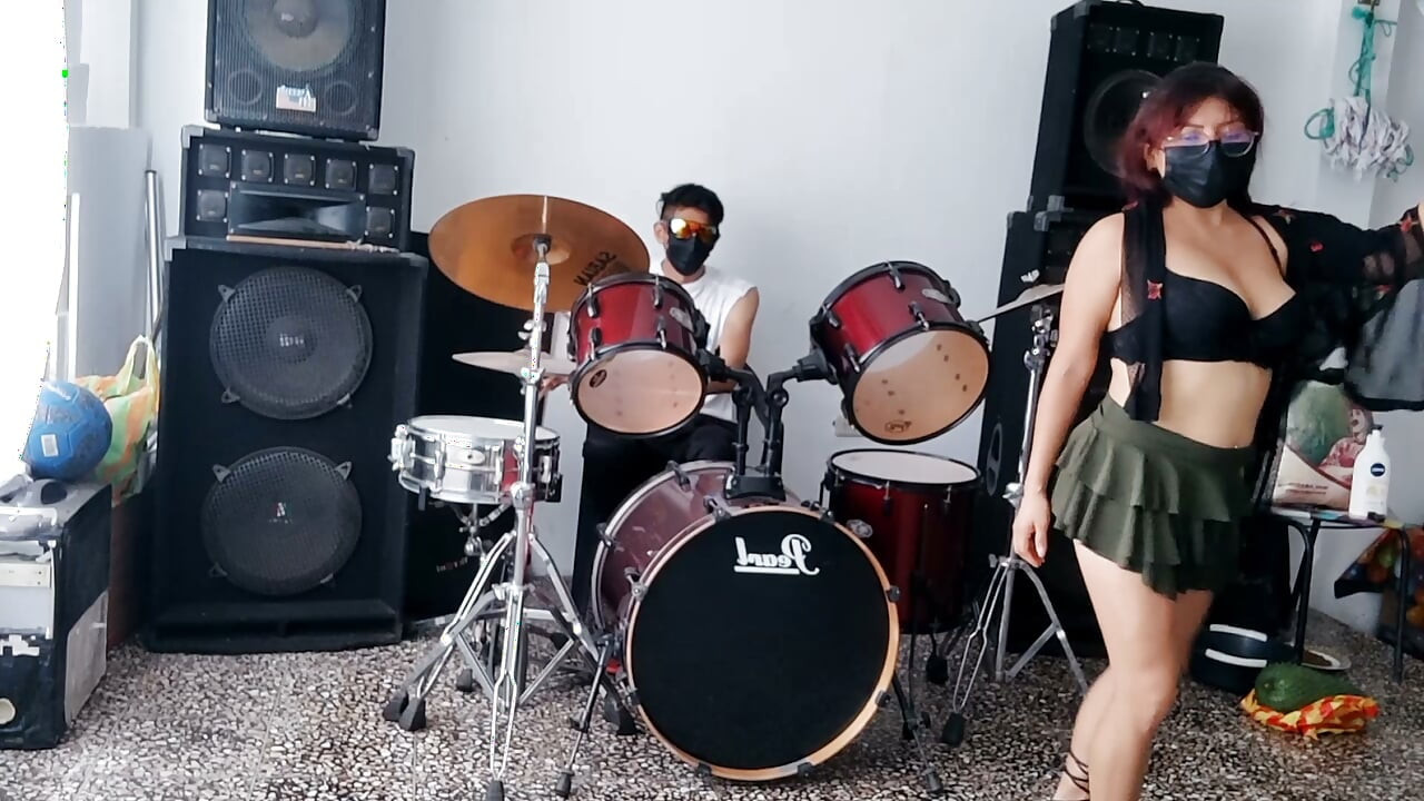 Best female friend performs a sexy dance for her male friend while he plays the drums.