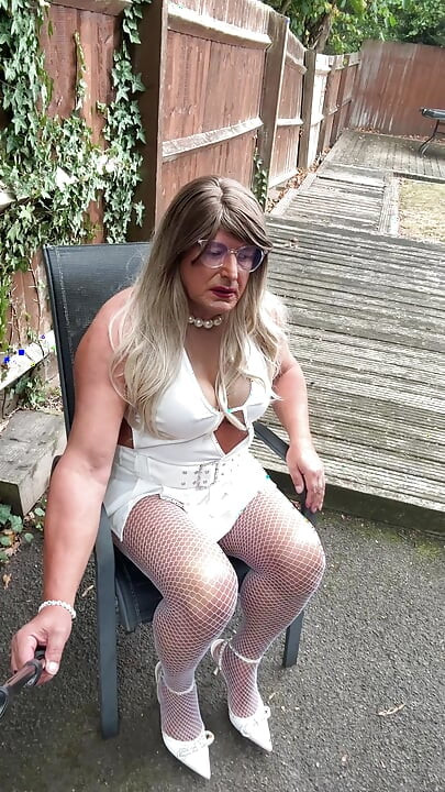 Sexy Crossdresser kellycd2022 in sexy white mini dress and fishnet pantyhose and heels