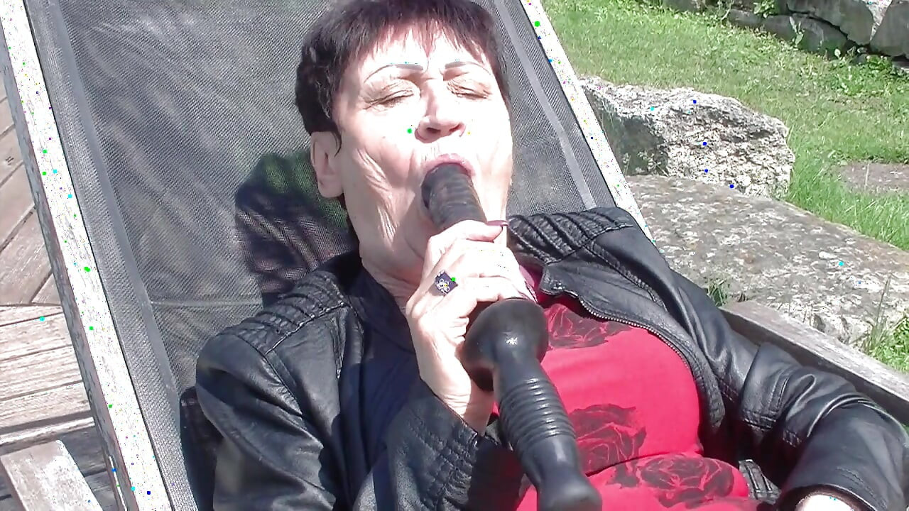 Granny enjoys dildo in garden