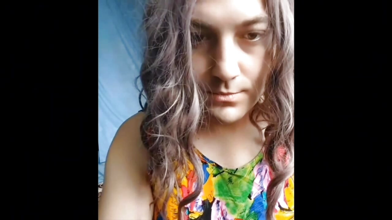Stunning trans beauty holding tea in cozy kitchen
