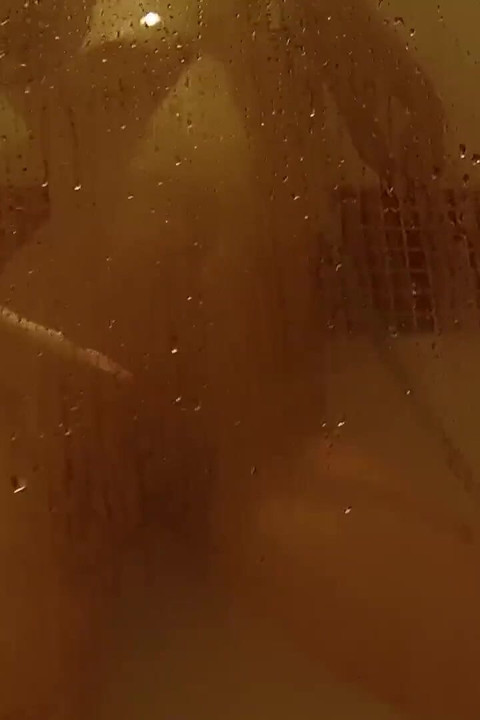 Solo brunette rubbing and gaping her pussy while showering