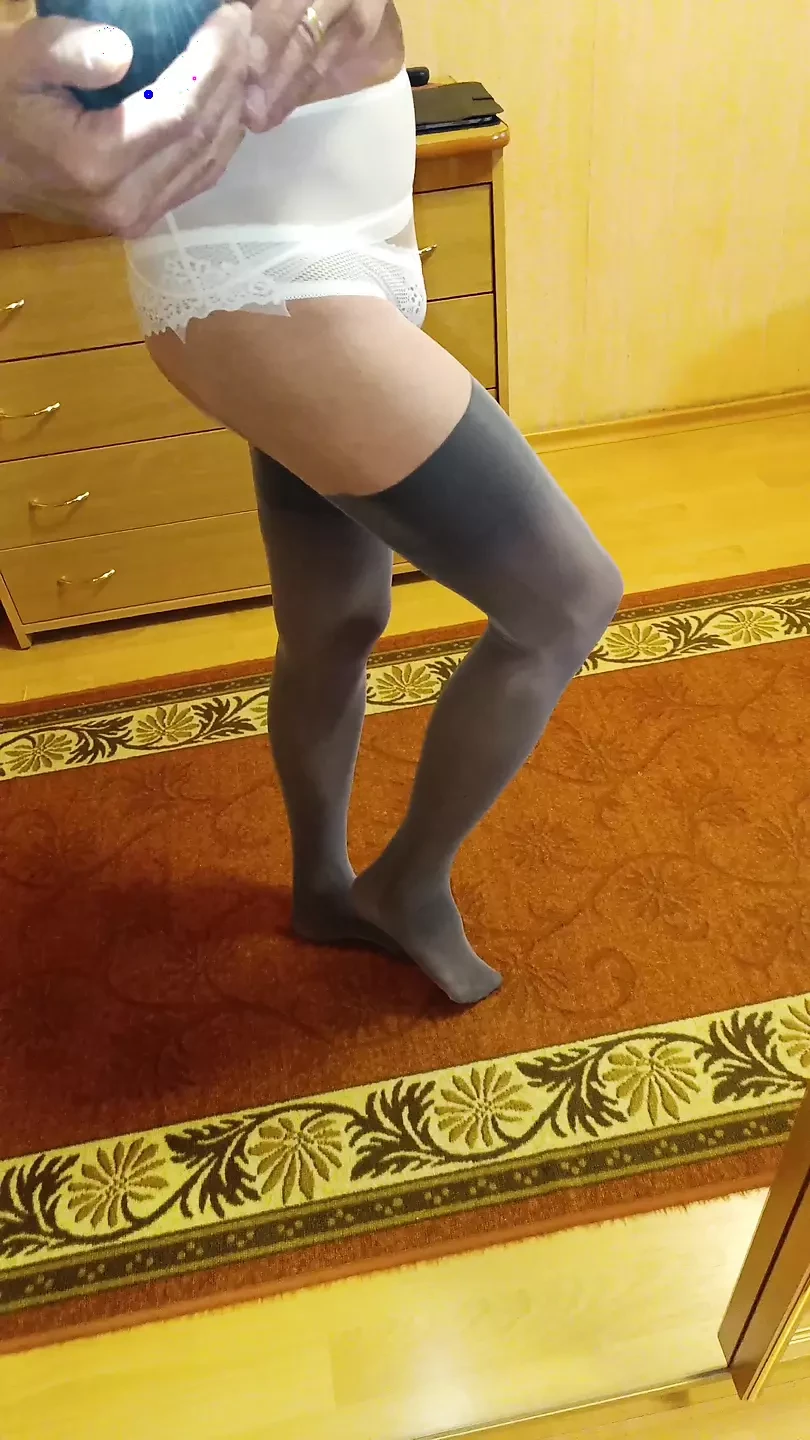 I'm wearing tights and panties and looking at myself in the mirror.
