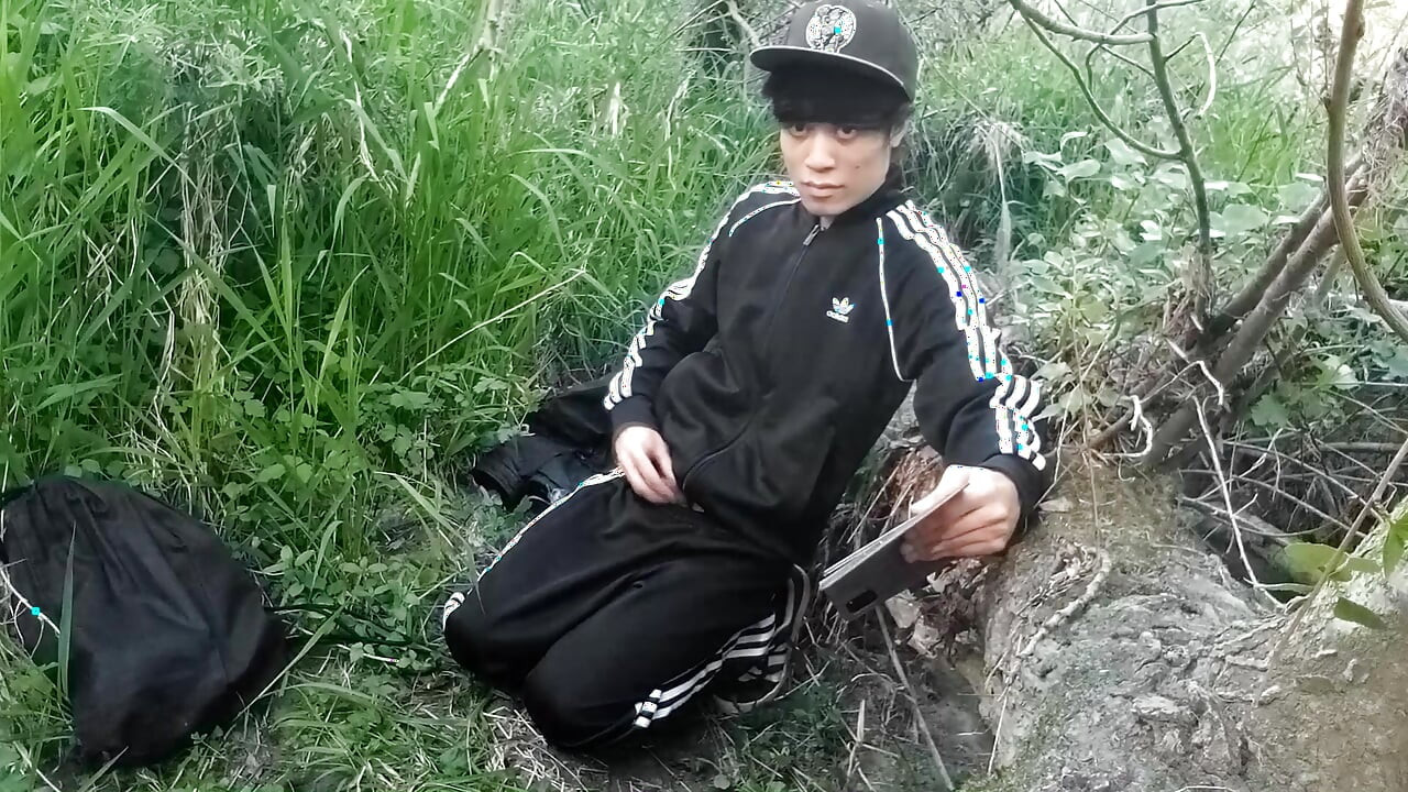 Cute Asian gay twink in a black-and-white adidas tracksuit and Campus sneakers masturbates and cums outdoors