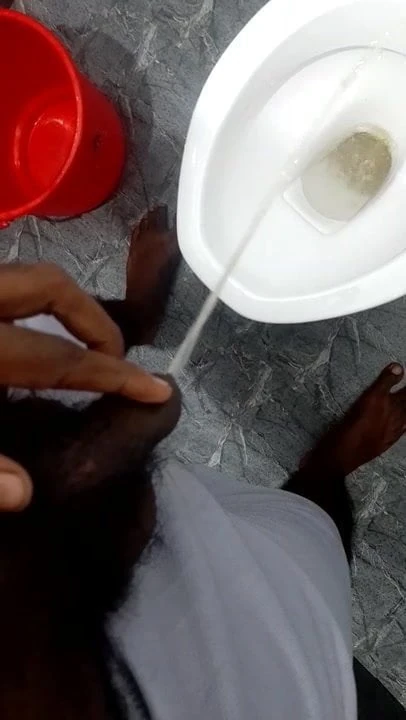 Men pissing in bathroom