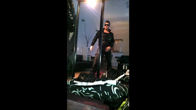 posing in black shiny nike trackies, black jacket
