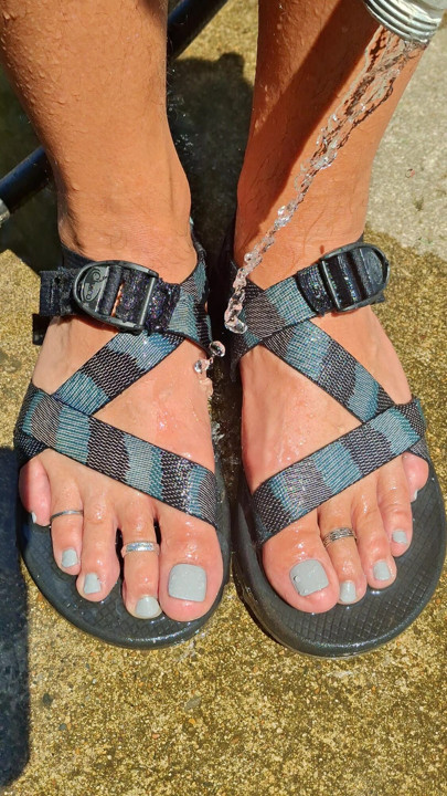 Cleaning off my pedicured feet and dirty sandals after a long hike