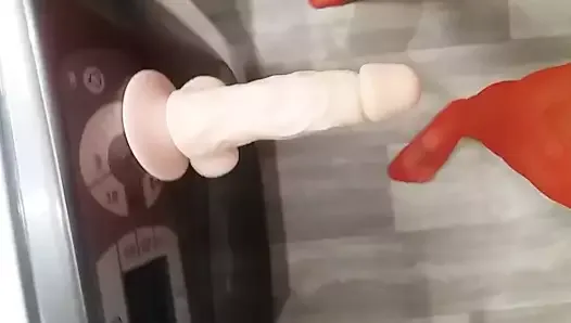 Realistic suction cup dildo on washing machine