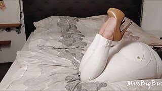 BWB MissBigButt wearing her high heel collection with white freddy leather pants and black latex corsage in bed