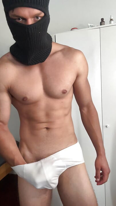 Young bodybuilder teasing in balaclava