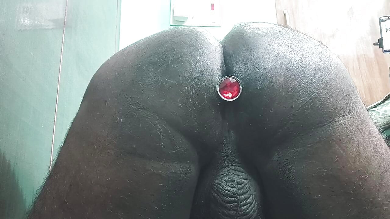 Toy anal butt plug pushing from the Ass hole