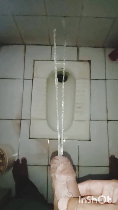 Younger boy Pissing in toilet