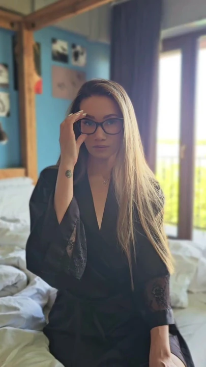 Hot asian woman with glasses in silk robe