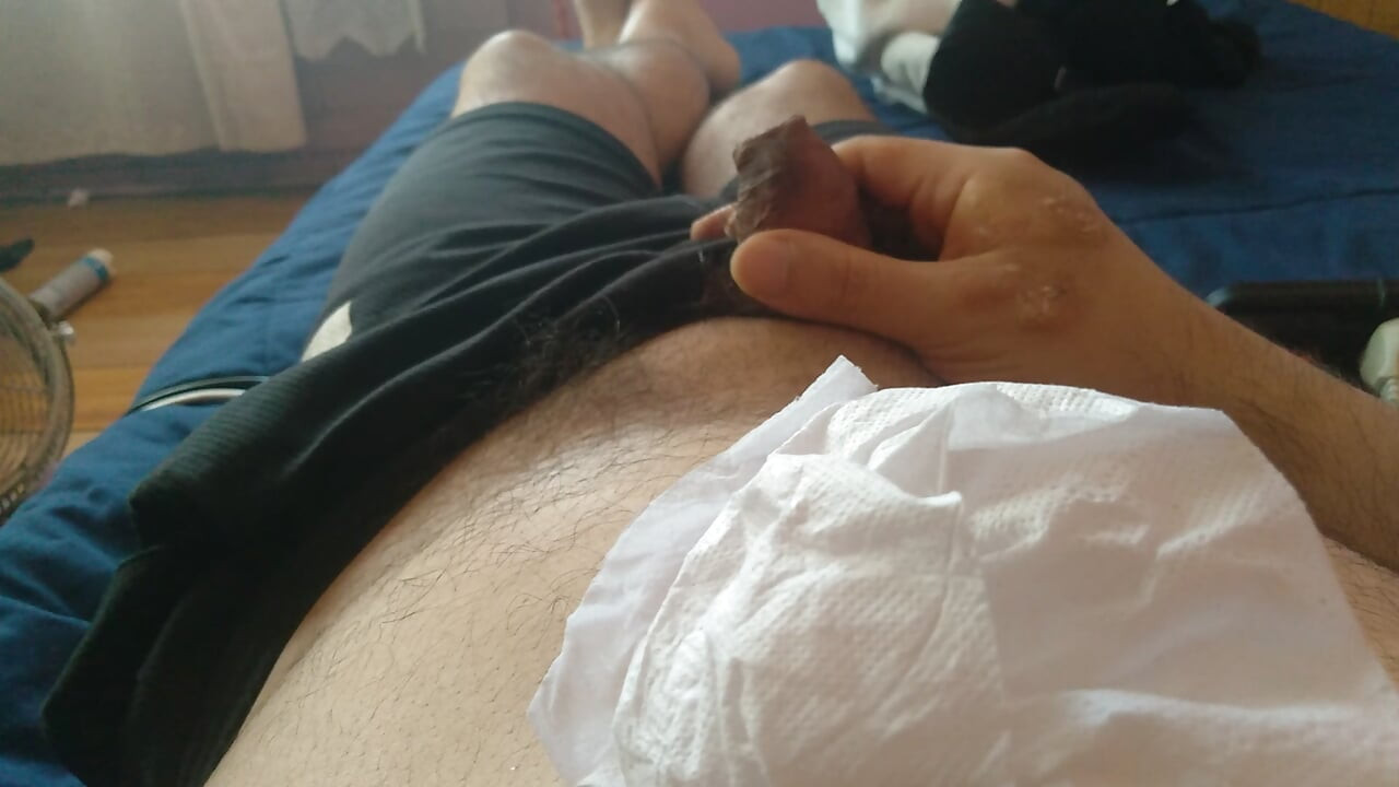 Man cleans his large penis of cum in his home