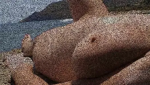 Julie Cunningham  lying nude on a beach