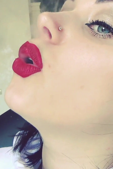 Smoke from dark red big lips