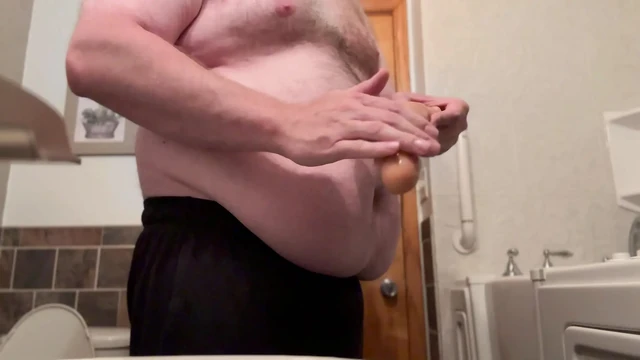 Fat Chub plays with dildo wearing a jock in his bathroom
