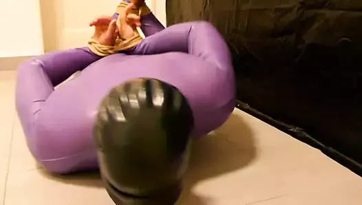 Male bondage. Gagged and hogtied in a purple latex catsuit. Tape gagged with duct tape, blindfolded. Barefoot bondage.