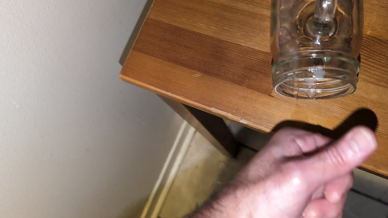Fat man jerking his hard cock and cumming in a glass