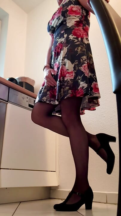 Secretary in floral dress pampering herself in coffee kitchen