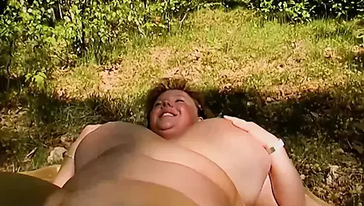 Chubby German lady rubbing her shaved pussy in the woods