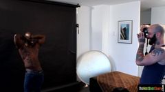 Ebony hunk cocksucking during photo shoot