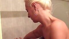 Blonde whore in heat shows her pussy while having a shower