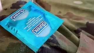 Jerking off in uniform into a condom already full of the cum of buddies