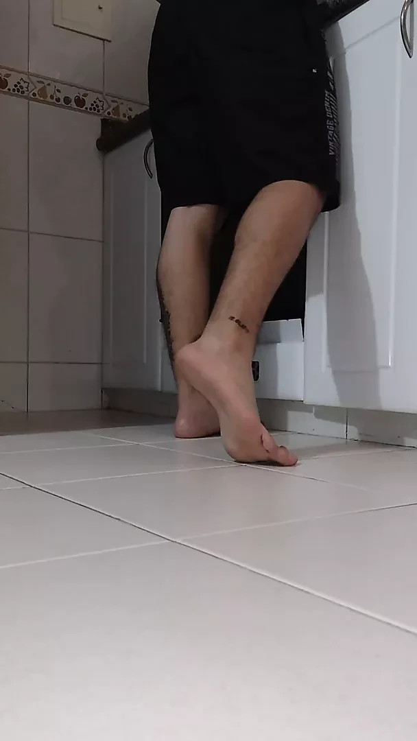 Latino shows his feet while cooking