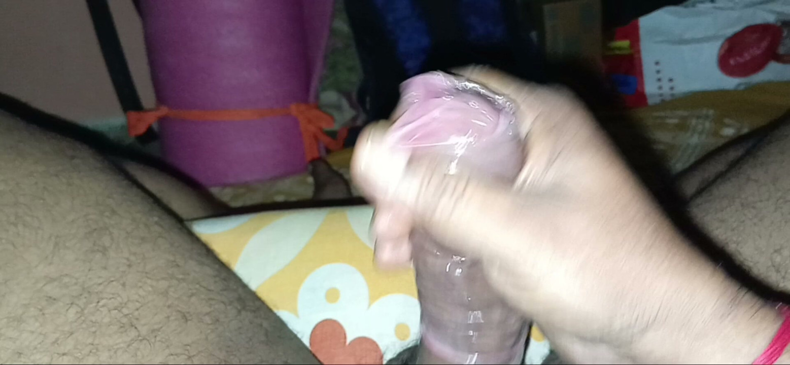 Pink condom handjob