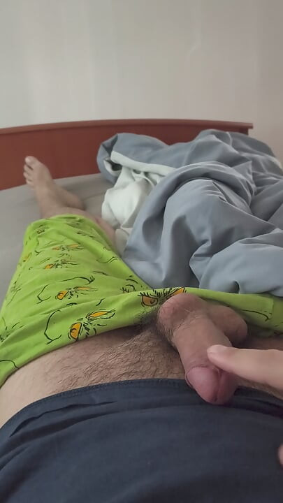 Cute handjob on the bed with a hard and erect penis