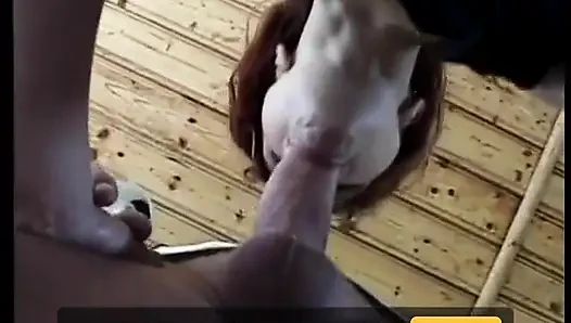 Horny slut redhead likes thirsty for cum on her mouth next to the house walls