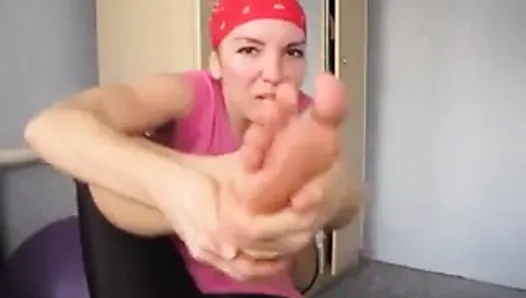 Girl works out and smells her stinky feet.