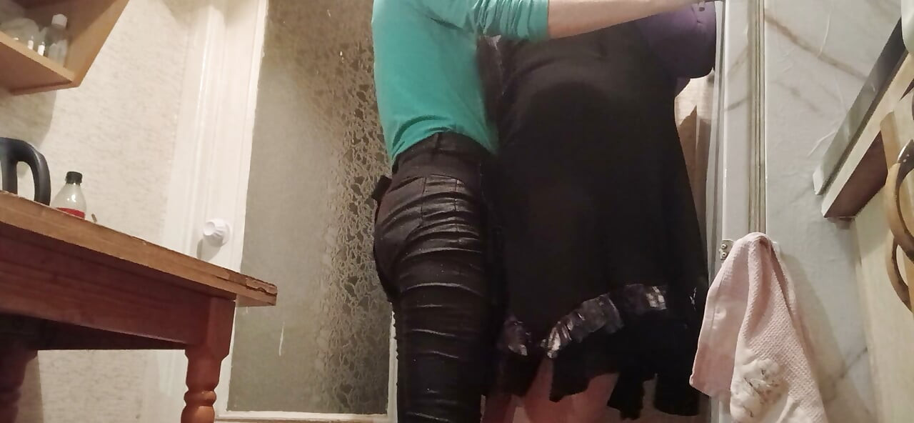 I’m fucking my married neighbor hard with a strap-on in the kitchen while her husband watches TV