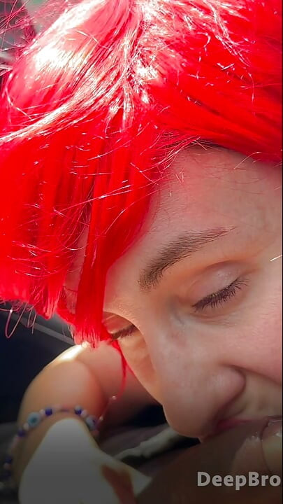 Redhead deepthroats thick BBC in the car, fingers gripping tight