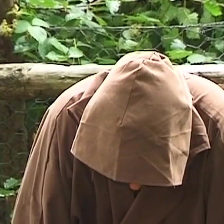 Hooded Mature Man Endures Clamps and Heavy Chains