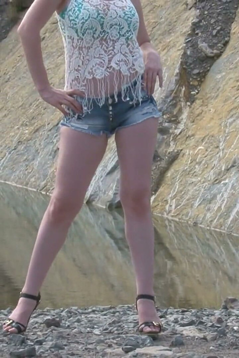 Big titted blonde babe is posing by the lake
