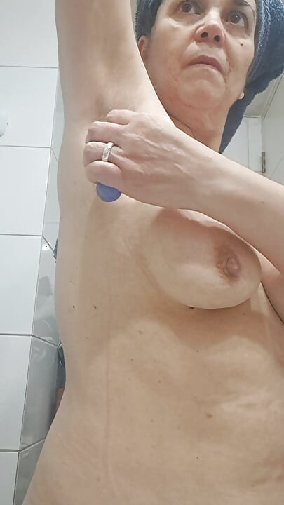 Mom shaves the few armpit hairs and some of the pubic hair on her hairy pussy