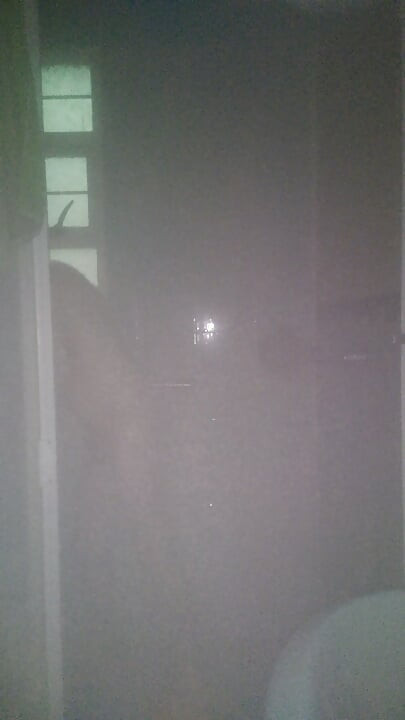 Man Showering with Flashlight On