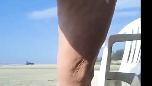 Hot crown sunbathing on the beach in transparent micro bikini