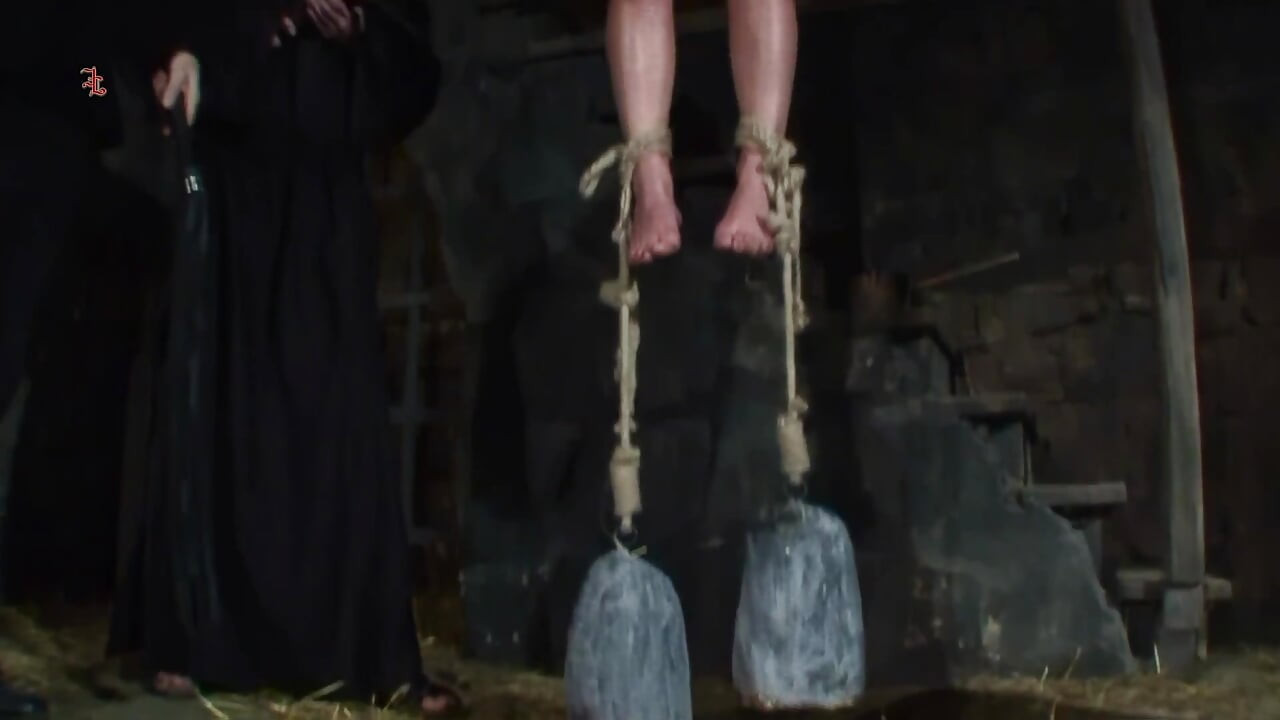 Blonde Girl Has Weights Attached to Her Feet and Is Hoisted up for Whipping