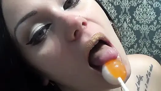 Golden lips teasing and lollipop sucking and licking