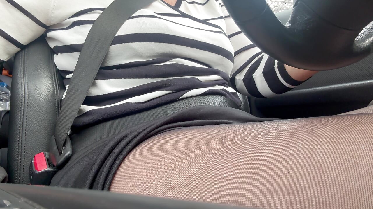 Elegant mature woman in nylon pantyhose driving home from the office