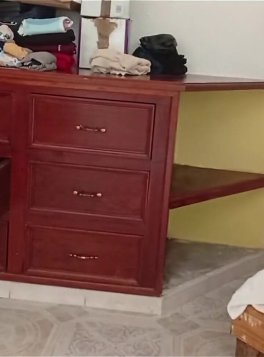 Molliges mädchen räumt das zimmer auf und faltt die kleidung